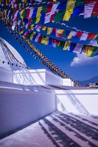 Multi colored wall against blue sky