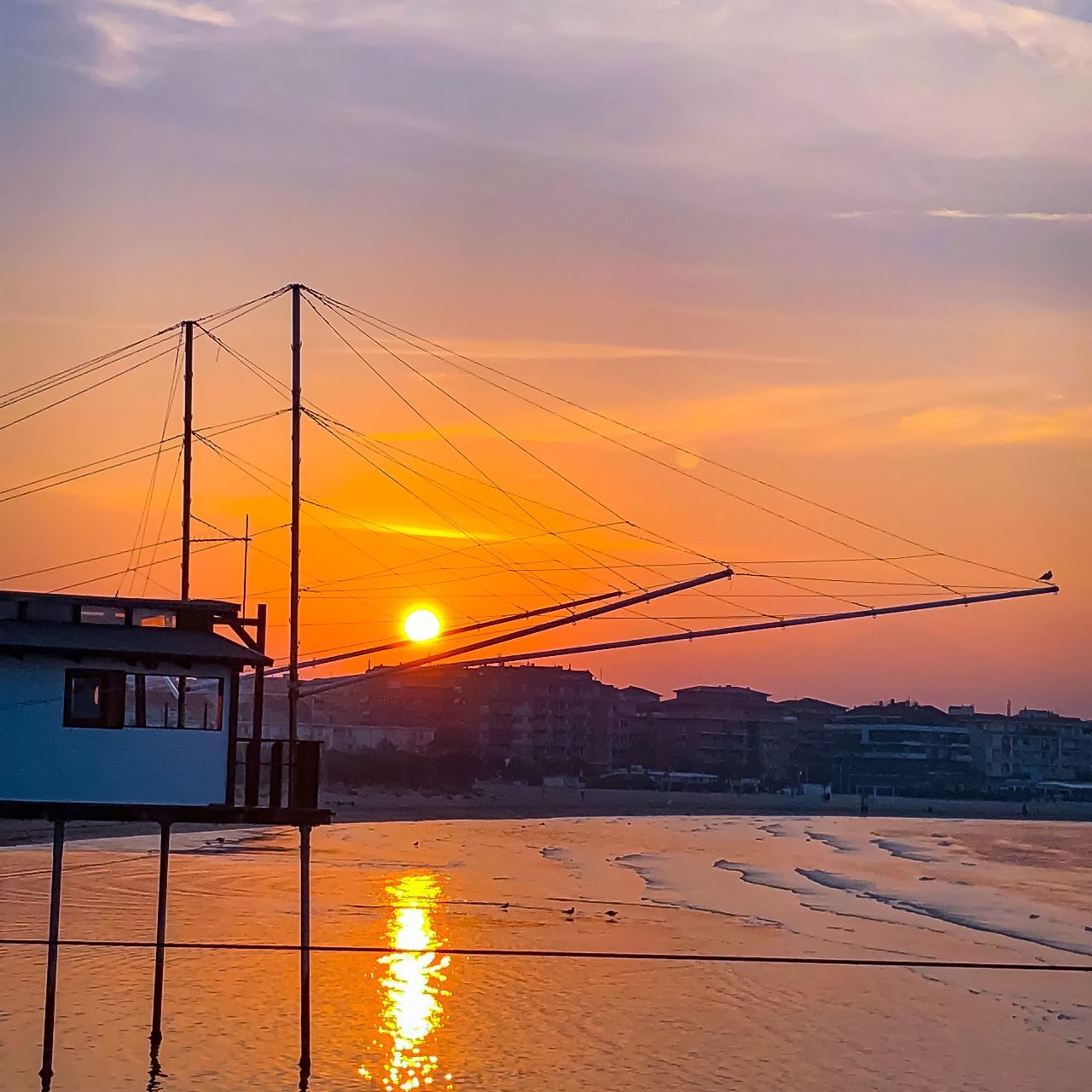 sunset, sky, orange color, water, sun, no people, nature, built structure, scenics, outdoors, architecture, beauty in nature, river, cloud - sky, silhouette, transportation, sunlight, building exterior, cold temperature, nautical vessel, city