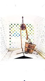 Electric lamp hanging on table against wall