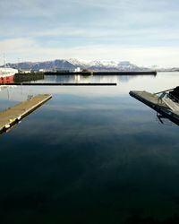 View of harbor against cloudy sky