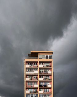 Low angle view of building against cloudy sky