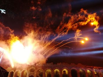Firework display against sky at night