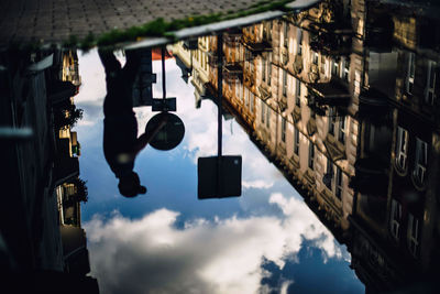 Reflection of building and man in water