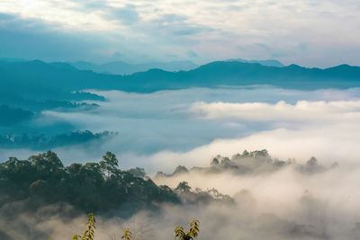 Scenic view of mountains against cloudy sky