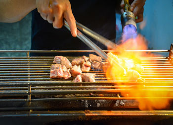 Man preparing food on barbecue grill
