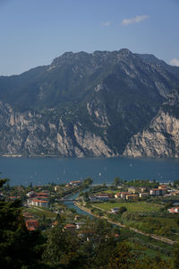 Aerial view of townscape and mountains against sky