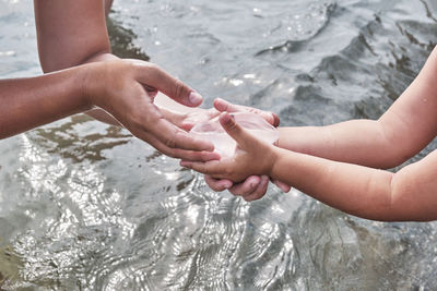 Close-up of hands holding water