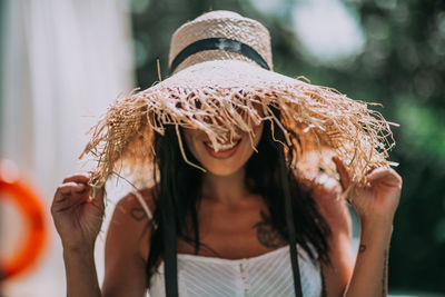 Portrait of woman wearing hat outdoors