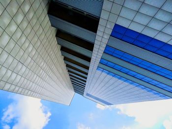 Low angle view of modern building against blue sky
