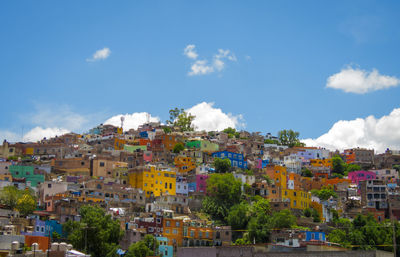 Buildings in town against blue sky