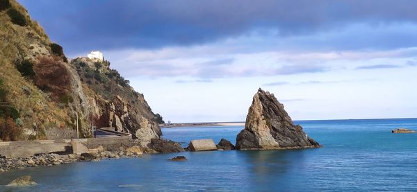 Panoramic view of rocks in sea against sky