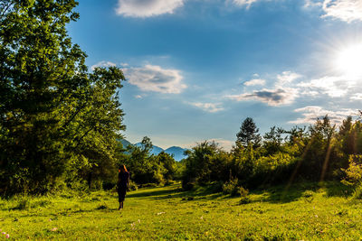 Man standing on field against sky