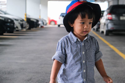 Cute boy standing in parking lot