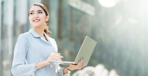 Young woman using mobile phone outdoors