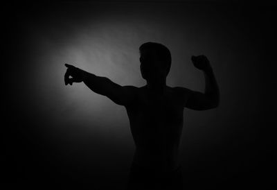 Rear view of silhouette man against gray background
