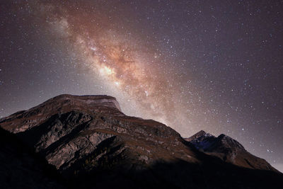 Scenic view of mountains against sky at night