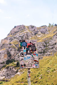 Information sign on rock against sky