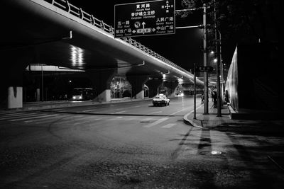 Illuminated walkway at night