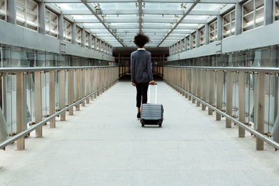 Rear view of man walking in bus