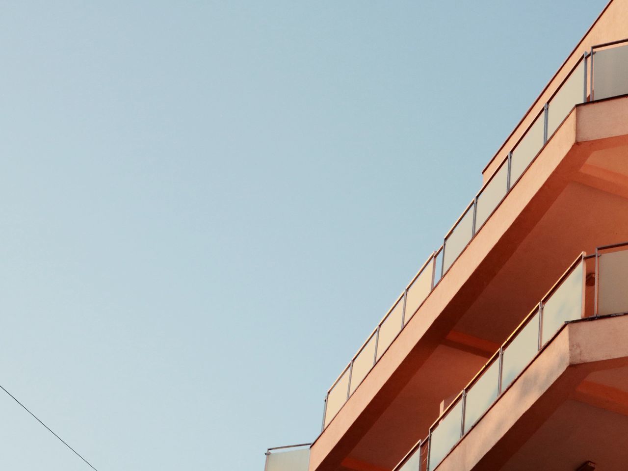 DIRECTLY BELOW SHOT OF BUILDING AGAINST CLEAR SKY