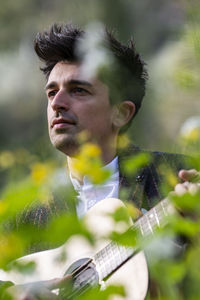 Close-up of young man playing guitar