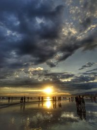 Scenic view of beach against dramatic sky