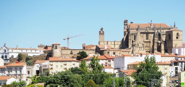 View of buildings in city against clear sky