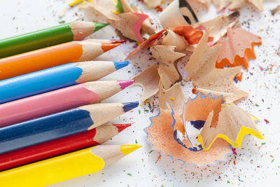 High angle view of multi colored pencils and shavings on table