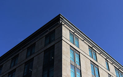 Low angle view of building against clear blue sky