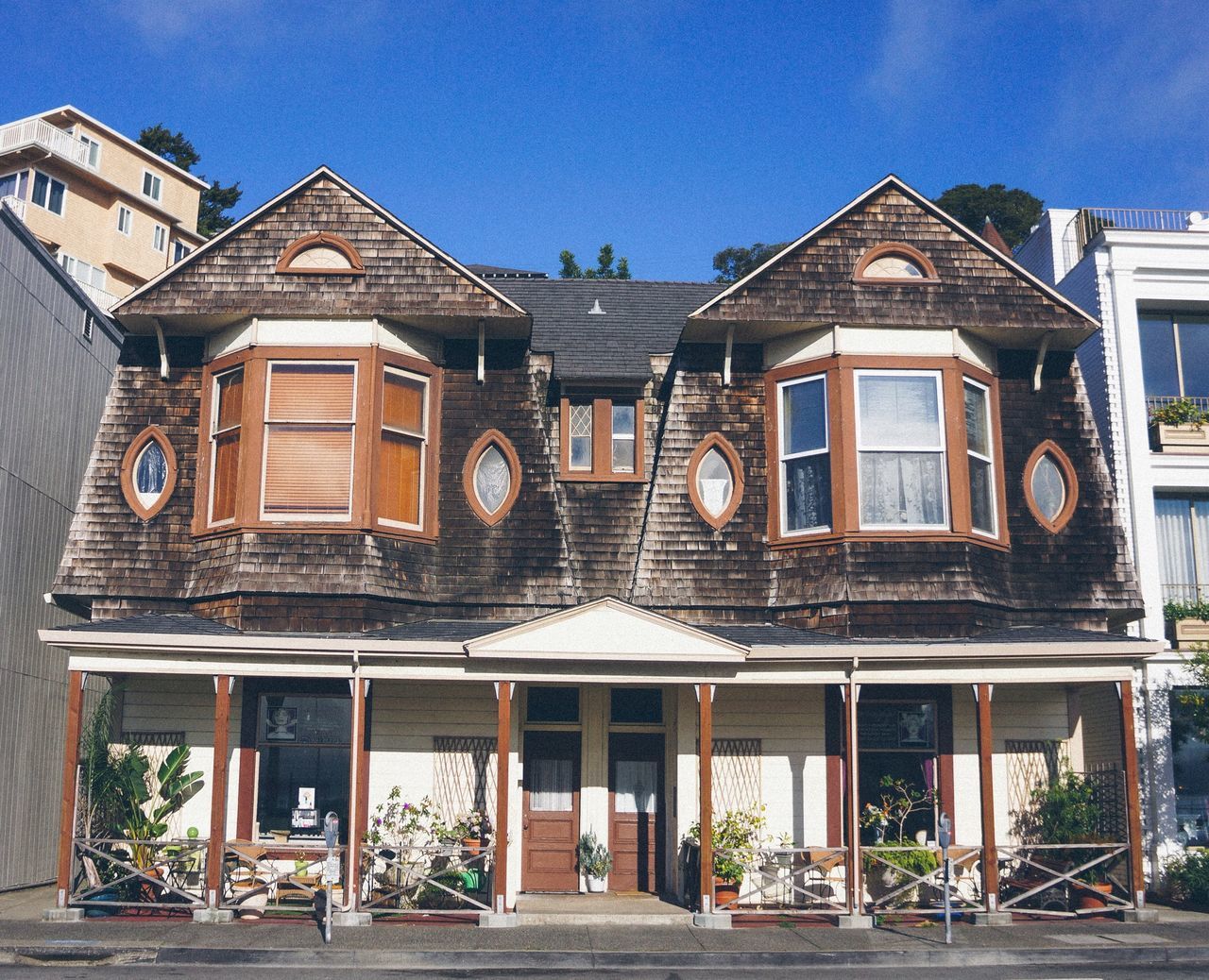 building exterior, architecture, built structure, house, roof, window, residential structure, facade, residential building, balcony, sky, low angle view, entrance, wood - material, door, outdoors, railing, day, blue, sunlight