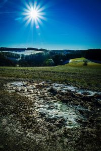 Scenic view of illuminated landscape against blue sky