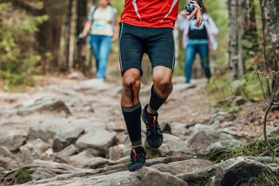 Low section of man running on rock