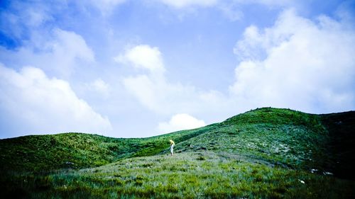 Scenic view of landscape against cloudy sky