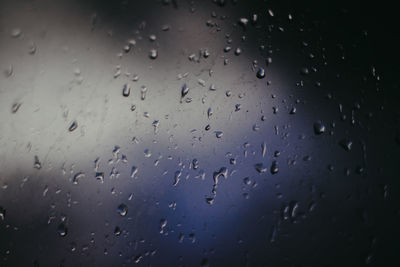 Full frame shot of raindrops on glass window