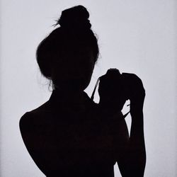 Silhouette woman standing against white background