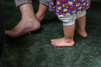 Low section of people on tiled floor