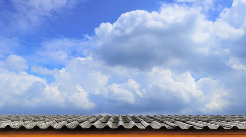 Low angle view of roof and houses against sky