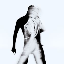 Rear view of woman standing against white background