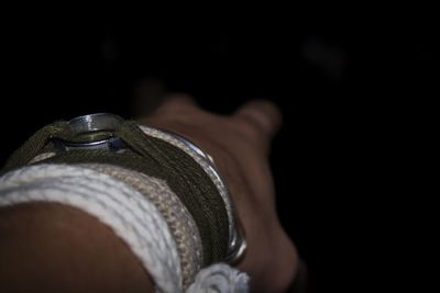 Close-up of human hand against black background