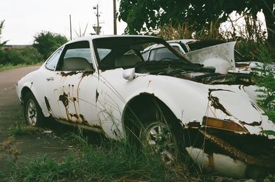 Abandoned car on field