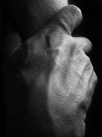 Close-up of man hand against wall