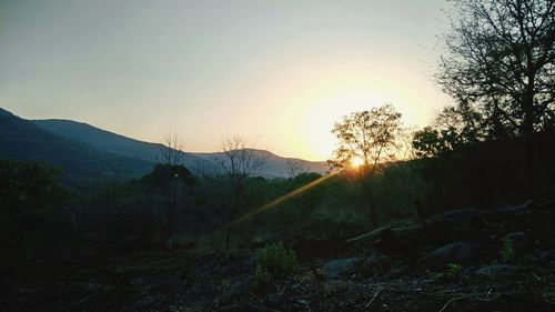 Scenic view of land against sky during sunset
