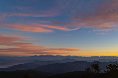 Scenic view of silhouette mountains against sky during sunset