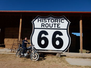 Man with bicycle sign on road