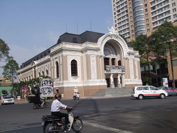 Municipal theatre by road against sky