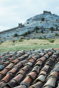 Stone wall of old building against sky