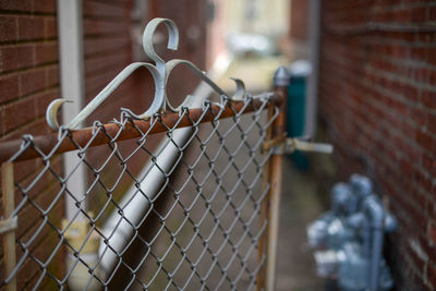 Close-up of metal fence against building