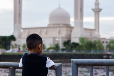 Rear view of boy looking at temple