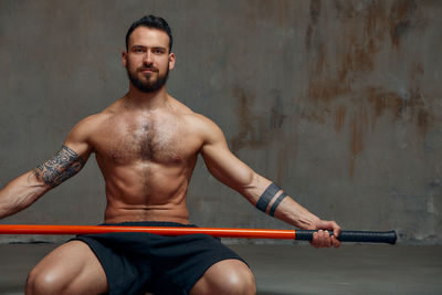 Portrait of young man exercising in gym