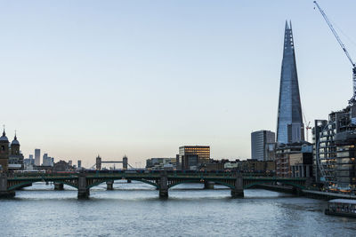 View of london's city centre and the thames river at sunset